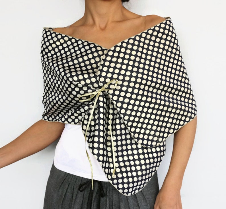 Reversible navy and gold polka dot taffeta shawl worn as a formal evening wrap with satin ribbon ties