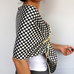 Navy polka dot evening shawl draped over the shoulders and secured with satin ribbon ties