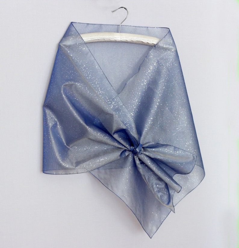 close up silver glitter organza fabric transparent evening shawl texture