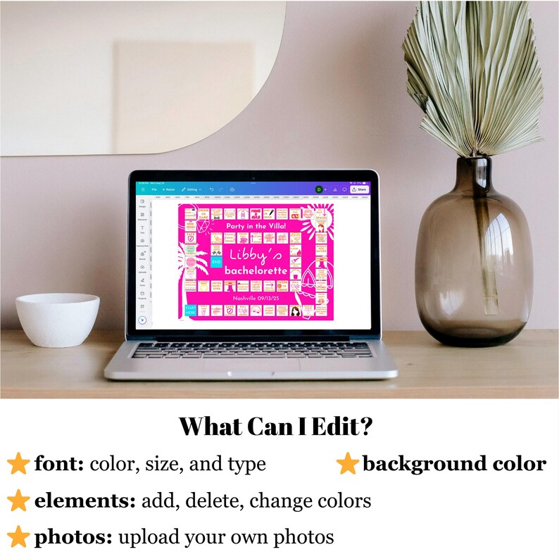 May include: A laptop displays a pink bachelorette party invitation with the text "Libby's bachelorette" and "Party in the Villa!" on the screen. The laptop is on a wooden surface, with a white bowl and a decorative vase with dried leaves nearby. The text "What Can I Edit?" is visible.