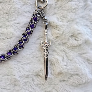 May include: A set of three ceramic mugs with a speckled, matte finish in cream, light grey, and dark grey. Each mug has a simple, minimalist design and a rounded handle.