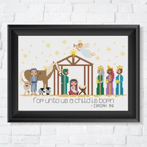 May include: A cross-stitch pattern featuring a nativity scene with a stable, a horse, a shepherd, three wise men, and an angel. The text "For unto us a child is born - Isaiah 9:6" is included.