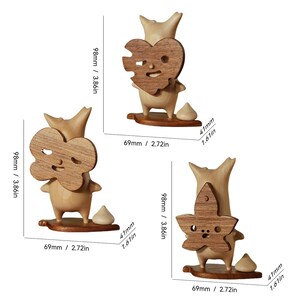 May include: Three wooden figurines with different shaped faces. Each figurine is holding a wooden cutout of a heart, a flower, and a star. The figurines are approximately 4 inches tall.