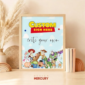 May include: A framed print featuring characters from the Toy Story movie franchise. The light blue background has the words "CUSTOM SIGN HERE" and "create your own". The print is in a light wood frame and includes the Design Mercury logo.