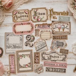 May include: A collection of vintage-style paper ephemera labels and tags featuring floral motifs, French typography, and numbers. The set includes rectangular and ornate die-cut shapes with printed text such as Eau de Cologne, Album, Hershey's Chocolate, and Paris.