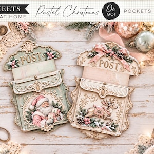 May include: Two decorative paper craft mail pockets featuring pastel Christmas themes. One pocket displays a vintage Santa Claus illustration, while the other features a reindeer. Both include the word POST, ornate scrollwork, and festive accents.