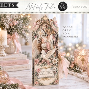 May include: A Nativity Folio Peekaboo Folio set containing 5 sheets. The central vertical card features an angel playing a trumpet, a dove, and the text Come let us adore Him. The design includes soft pink and cream tones with floral accents.