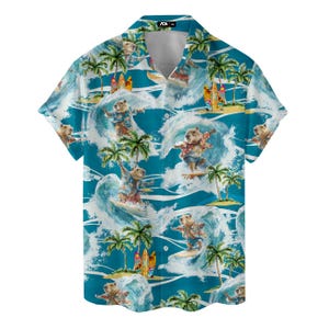 May include: Short-sleeved button-down shirt with a vibrant tropical print. The design features cartoon capybaras surfing on ocean waves, palm trees, and surfboards against a turquoise background. The shirt has a classic collar and a relaxed fit.