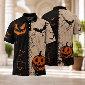 May include: A short-sleeve polo shirt featuring a split design with a black side and a beige side. The print includes orange jack-o'-lanterns, black silhouettes of flying bats, and a distressed texture pattern across the entire garment.