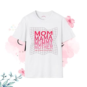 May include: White t-shirt with a pink graphic that reads "MOM MAMA MUMMY MOTHER" in a grid pattern. Below the text is the phrase "ONE PERSON INFINITE LOVE". The shirt has a crew neck and short sleeves.