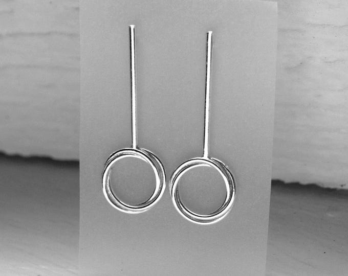 Silver earrings with a linear design and intertwined circles – Handmade minimalist long earrings.