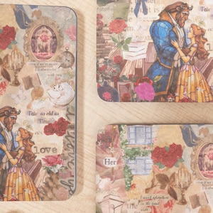 May include: Decorative paper cutouts featuring illustrations from "Beauty and the Beast." The designs include images of the characters, roses, and text like "Tale as old as Time" and "love." The color palette is a mix of warm tones with a vintage aesthetic.