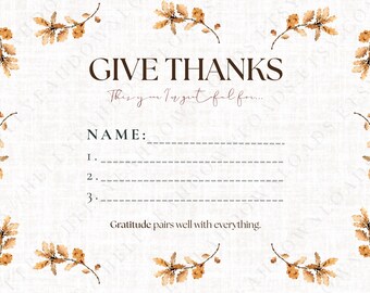 May include: A cream-colored Thanksgiving card with the words "GIVE THANKS" in brown. The card includes space to write a name and three things to be grateful for. Watercolor-style branches with brown leaves frame the card.