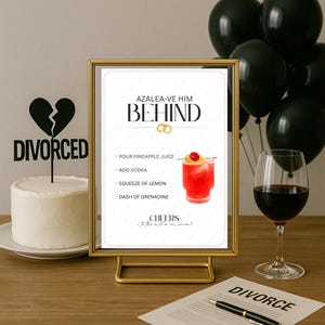 May include: A humorous divorce-themed display. A cake with a "Divorced" topper, a cocktail recipe sign, a glass of red wine, and a divorce document with a pen. Black balloons are in the background.