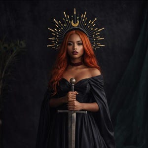 May include: A person with long orange hair wearing a black off-the-shoulder dress and a black halo crown featuring gold star and sword-shaped spikes with a central gold crescent moon. The person holds a silver sword with both hands in front.