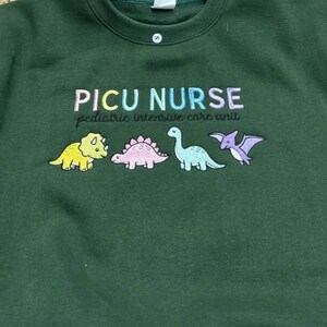 PICU Nurse Dinosaur Embroidered Sweatshirt, Pediatric Nurse Crewneck, Cute Dino Scrubs Top, NICU Nurse Gift, Medical Worker Apparel image 2