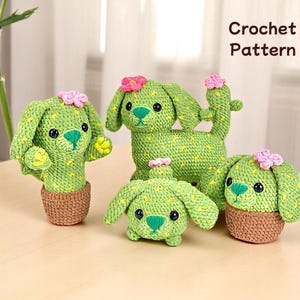 May include: Four crocheted cactus dog figurines. The dogs are green with yellow accents and pink flowers on top. The dogs are in different poses, including sitting, standing, and lying down. The dogs are all in pots.