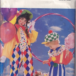 May include: A vintage sewing pattern for a clown costume. The pattern is for a child's costume and includes a red and white striped shirt, blue and white striped pants, and a red hat with a green and white checkered pattern. The pattern is from Butterick and the number is 6846. All sizes are included.