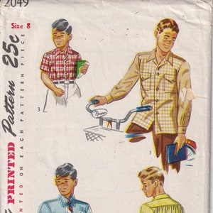 May include: A vintage Simplicity sewing pattern for a boy's shirt. The pattern is for size 8 and costs 25 cents. The pattern includes three different shirt styles, all with short sleeves and button-down collars. The pattern is printed on a white background with black text.
