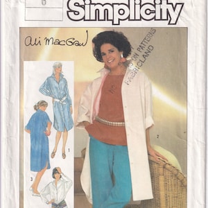 May include: Simplicity sewing pattern number 6846 for a long-sleeved shirt dress with a button-down front and a belt. The pattern includes four different views, with one view featuring a white shirt with a long, flowing white jacket. The pattern is designed by Ali MacGraw.