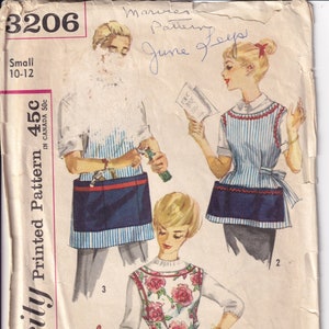 May include: Vintage Simplicity sewing pattern 3206, featuring illustrations of aprons with floral and striped designs. The pattern includes instructions for making aprons, with the text "Simple to Make".