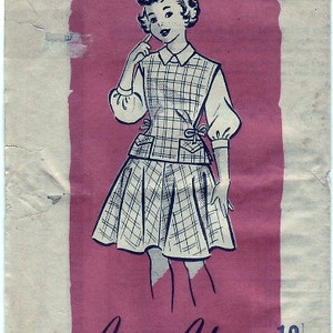 May include: A vintage sewing pattern for a plaid dress with a vest. The pattern is for size 12 and is by Anne Adams. The pattern number is R4871.