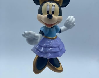 May include: A purple and blue dress with gold accents, Minnie Mouse figurine keychain.