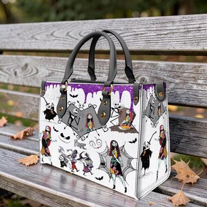 May include: A white ceramic mug with a black handle and the text "But First, Coffee" in a bold, black font. The mug is set against a blurred background, suggesting a cozy setting.