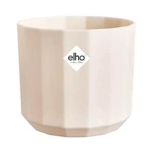 May include: A cream-coloured plant pot with a modern design. The pot has a ridged, vertical pattern and a geometric base. The brand name "elho" is displayed on a white diamond-shaped label on the front.