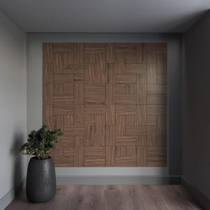 May include: A room with a gray wall and a wooden wall panel made of small squares. A potted plant sits in the corner of the room.