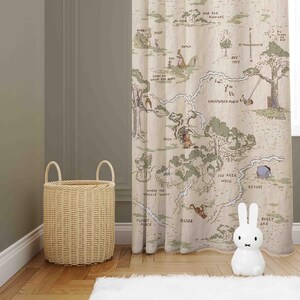 May include: A Winnie the Pooh themed shower curtain featuring a map of the Hundred Acre Wood with various characters and locations, including Rabbit, Piglet, Kanga, Roo, Eeyore, Tigger, and Christopher Robin. The curtain is beige with brown and green illustrations.