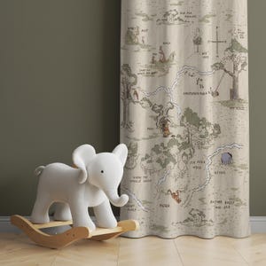 May include: A beige fabric curtain with a Winnie the Pooh map printed on it. The map shows the Hundred Acre Wood with locations like Pooh's house, Piglet's house, and the Bee Tree. A white rocking elephant toy is in the foreground.
