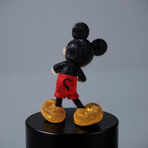 Rear view of the "MICKEY LOVE" Pop Art statue by NOISYX, showcasing the back of the figurine. The sculpture is entirely covered in hand-applied black, gold, and red glass crystals, with special attention to the shimmering red shorts and golden shoes. This exclusive and signed collectible art piece highlights its unique luxury and bling aesthetic, making it an ideal statement piece for any art or design collection.