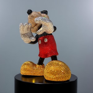 Detailed close-up of the lower half of the "MICKEY LOVE" pop art statue. The image highlights the intricate hand-applied red glass crystals on Mickey Mouse's shorts and the gold and black rhinestones on his shoes and feet. The luxurious craftsmanship and sparkling bling aesthetic are clearly visible, confirming the quality of this signed collectible figurine. This unique handmade sculpture by NOISYX is a perfect statement piece for high-end home decor.