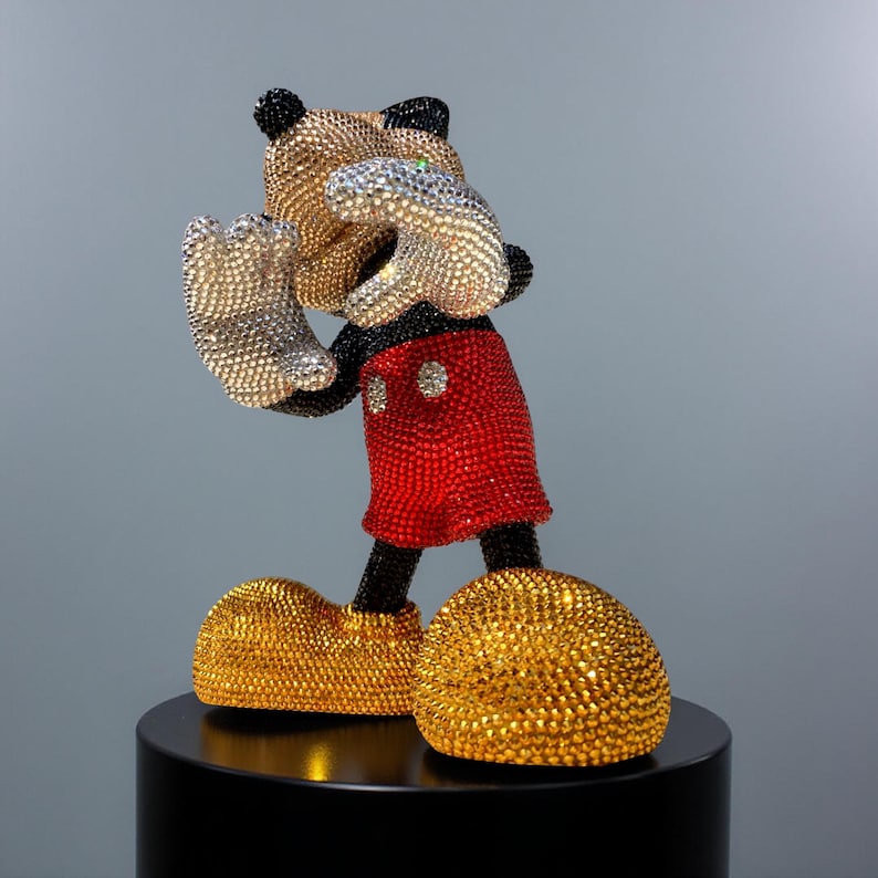 Detailed close-up of the lower half of the "MICKEY LOVE" pop art statue. The image highlights the intricate hand-applied red glass crystals on Mickey Mouse's shorts and the gold and black rhinestones on his shoes and feet. The luxurious craftsmanship and sparkling bling aesthetic are clearly visible, confirming the quality of this signed collectible figurine. This unique handmade sculpture by NOISYX is a perfect statement piece for high-end home decor.