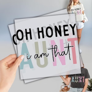May include: A white graphic tee with the text "Oh Honey I am that Aunt" in black and colorful lettering. The text is layered with a light blue, light green, pink, and light pink color scheme.