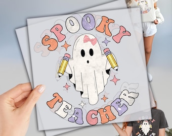 May include: A light gray print featuring a cartoon ghost with a pink bow, holding pencils, and the words "Spooky Teacher" in a retro font. The design includes stars and pastel colors, perfect for Halloween or a teacher's gift.