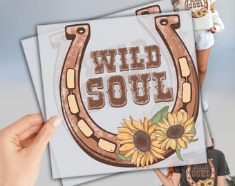 May include: A brown horseshoe with the text "WILD SOUL" in brown lettering. The horseshoe is decorated with sunflowers.