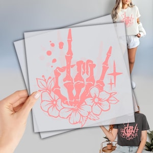 a person holding up a piece of paper with a drawing on it