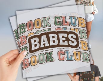 May include: A stack of colorful stickers with the text "Book Club Babes" repeated multiple times. The stickers are on a white background.