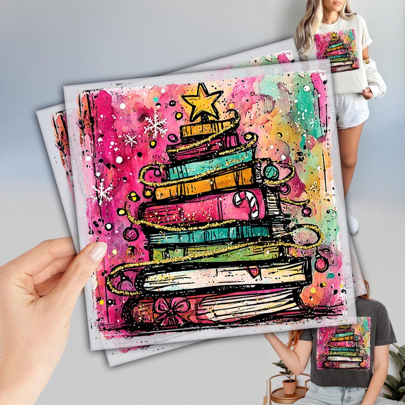 A hand holding a colorful, whimsical book-themed greeting card featuring a stack of books with a star at the top.