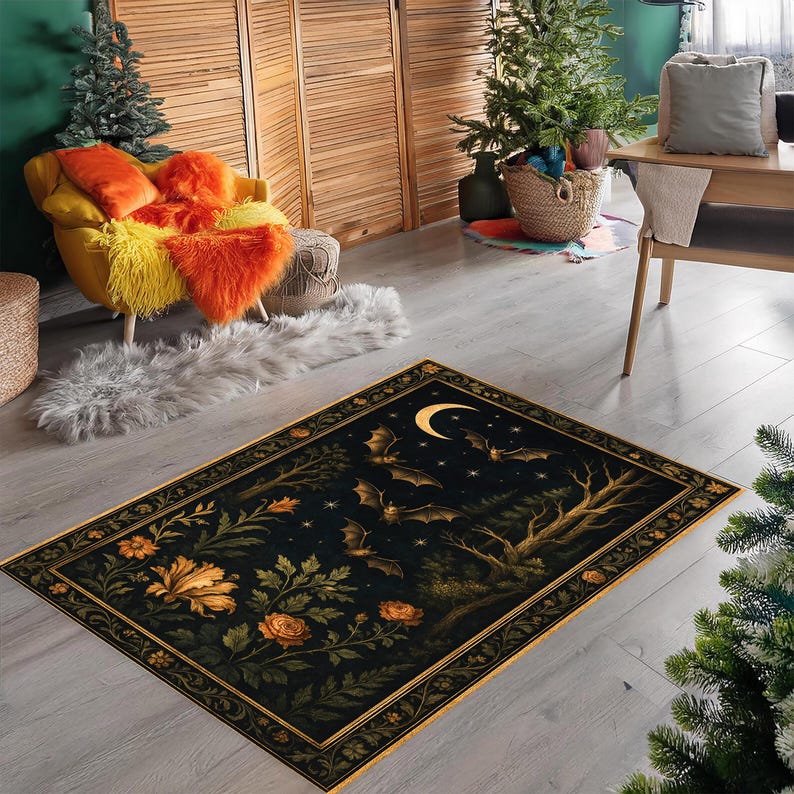 May include: A rectangular area rug with a dark background featuring a night scene with bats, a crescent moon, and stars. The rug has a floral border with orange and yellow flowers and green leaves. The rug is placed on a light gray wooden floor.