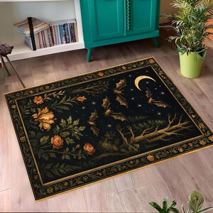 May include: A rectangular rug with a dark background featuring bats, a crescent moon, and stars. The rug has a floral border and floral and foliage designs in shades of gold and green. The rug is on a wooden floor.