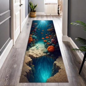 May include: A rectangular hallway rug depicting an underwater ocean scene. The design features orange and teal coral, schools of orange fish, and a deep blue abyss. The rug is placed on a wooden floor.