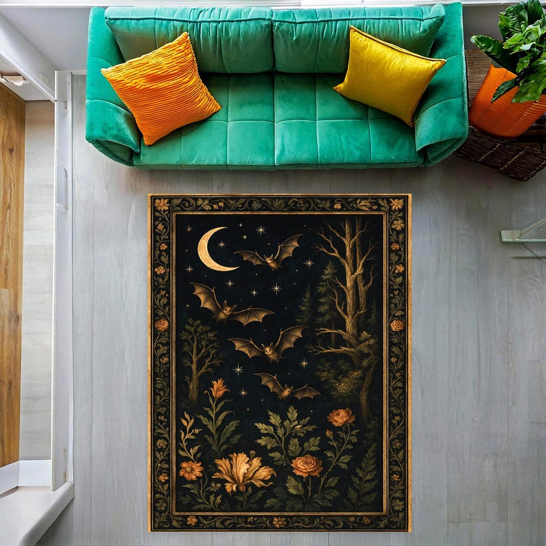 May include: A rectangular rug with a dark background featuring a crescent moon, bats, trees, and flowers. The rug has a decorative border with floral elements. The color palette includes black, gold, and shades of brown and orange.
