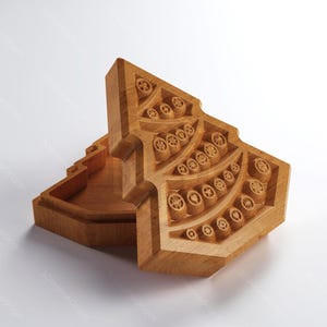 May include: A wooden, geometric box with a lid, featuring intricate carved circular and star-shaped designs. The box is light brown and appears to be made of wood. The lid is partially open, revealing the interior. The image also includes icons for digital file formats.