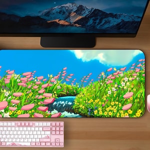 May include: A colorful mousepad with a cartoon landscape featuring a stream, flowers, and a blue sky. The mousepad is rectangular and has a smooth surface.