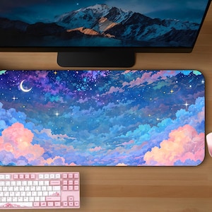 May include: A large mouse pad with a colorful illustration of a night sky with clouds and stars. The mouse pad is rectangular and has a smooth surface.