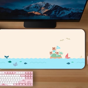 May include: A light blue and beige mousepad with a cartoon island scene. The island has three brown animal characters, a palm tree, and a red sailboat. The text "Serene Town" is in the bottom right corner.