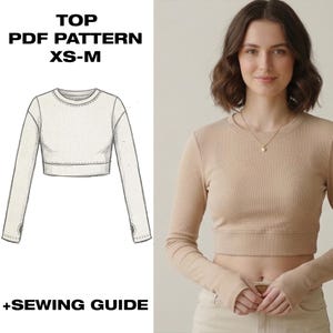 May include: A beige long-sleeved crop top with thumb holes, paired with light-colored pants. The top is ribbed and has a crew neck. The image also includes a line drawing of the top with the text "TOP PDF PATTERN XS-M +SEWING GUIDE."